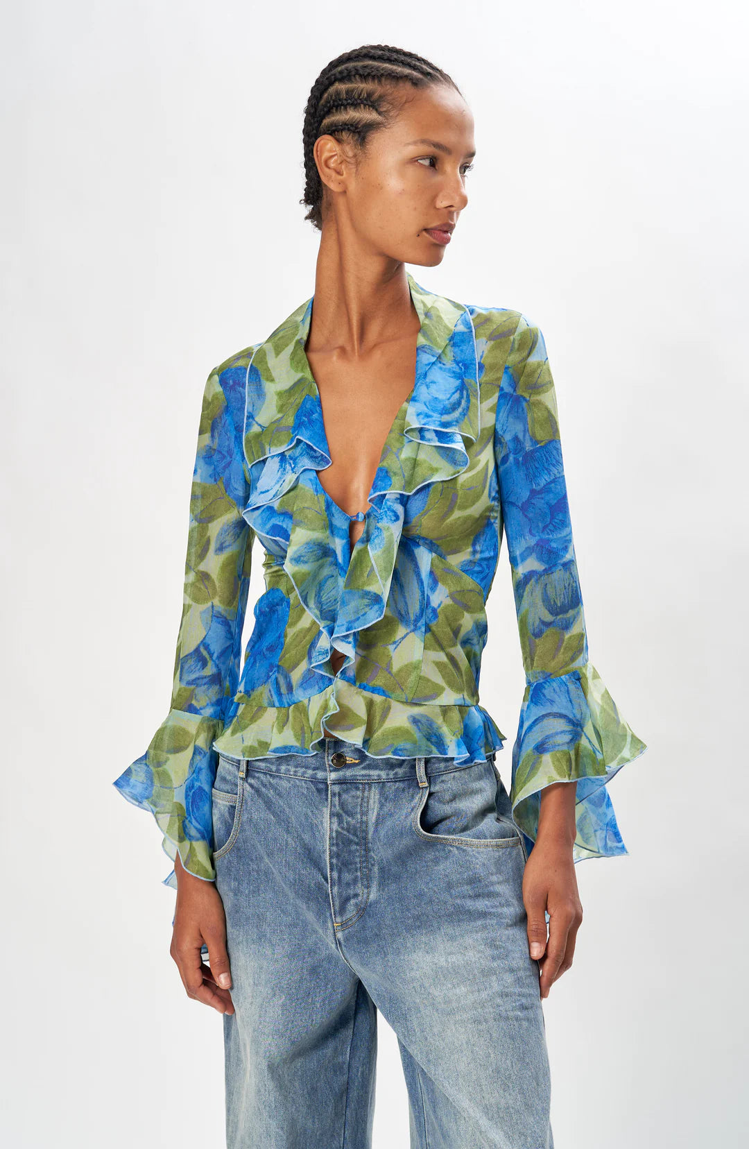 Ronny Kobo Alisha blue floral chiffon ruffle blouse, three-quarter side view showing the bell cuffs