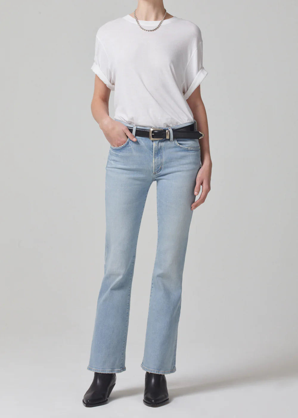 Citizens of Humanity Lupita white crewneck t-shirt with rolled sleeves worn with light wash flare jeans, full-length front view