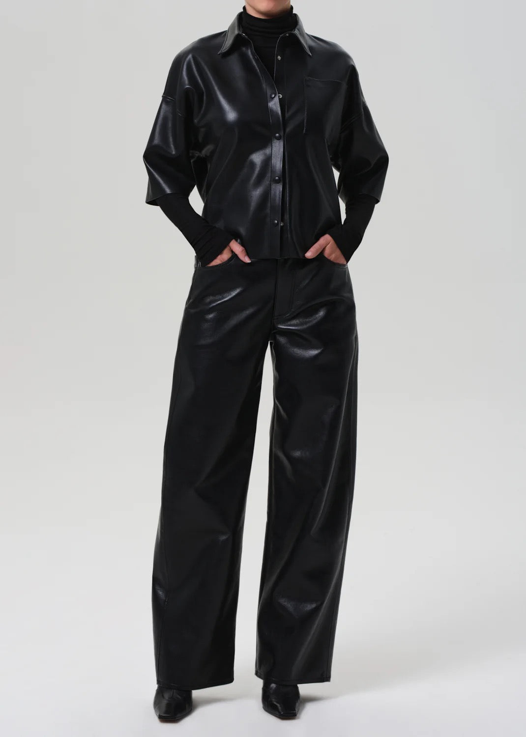 Shoulder and seam detail of Frances Crop Cape Button Up – Black, structured silhouette