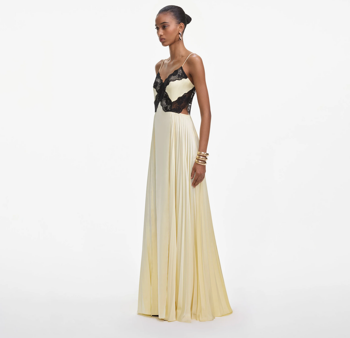 Side view of the Self-Portrait satin lace maxi dress in yellow, showing side cut-out and pleated skirt