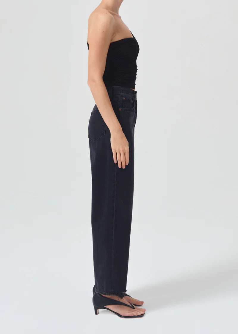 AGOLDE Domino black one-shoulder gathered top worn with black jeans, side view