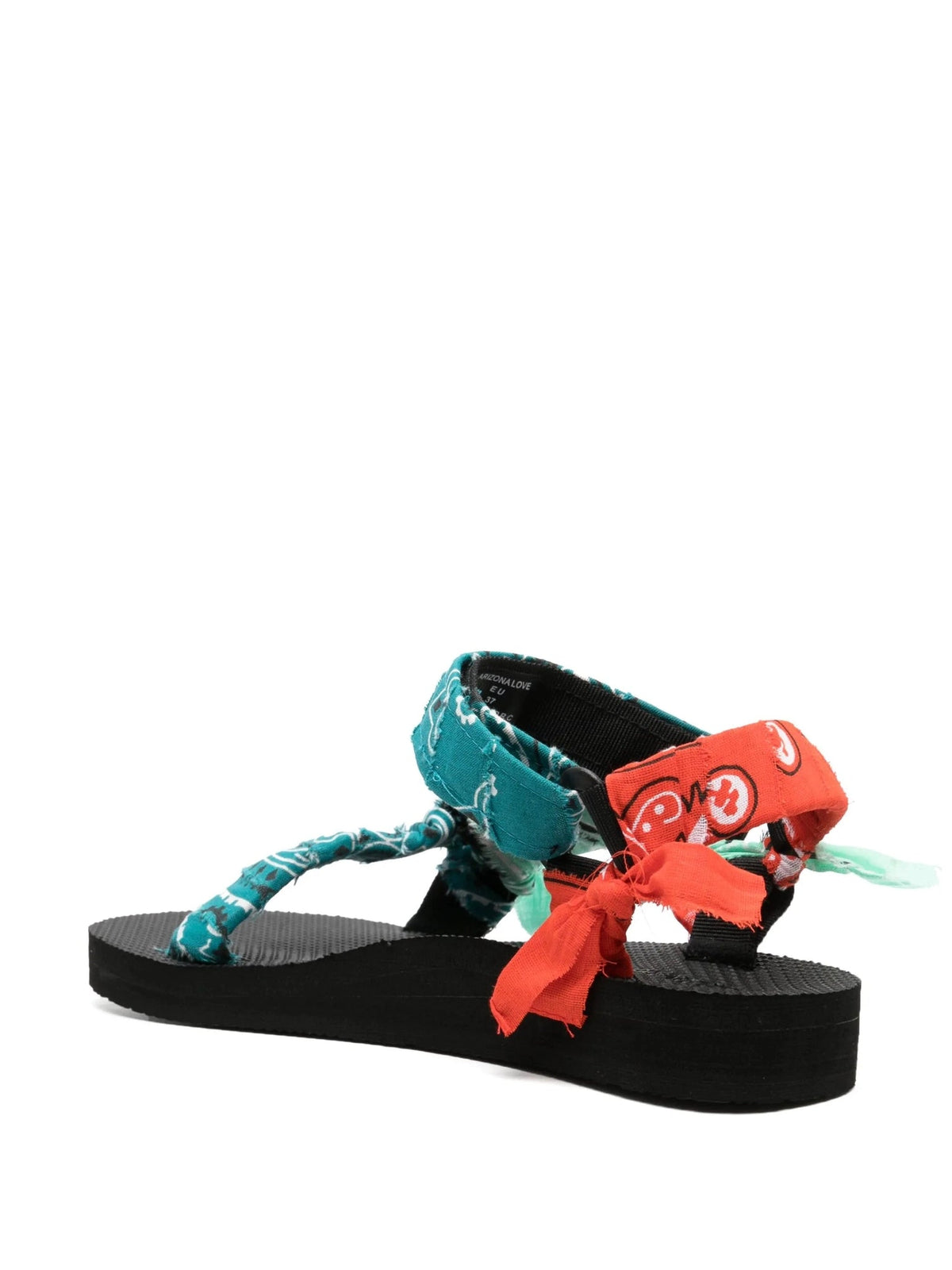 Three-quarter view of the Trekky sandals in Mixed Teal Bandana showing the ankle strap and bow details