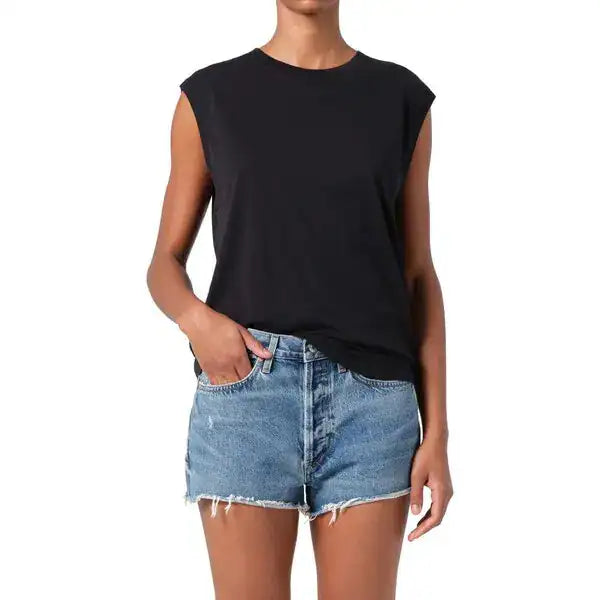 Front view of the black AGOLDE Raya muscle tee with extended shoulders, worn with denim shorts