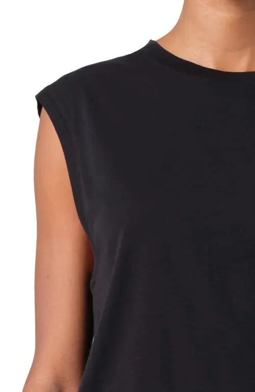 Close-up of the crew neckline and extended shoulder on the black Raya muscle tee