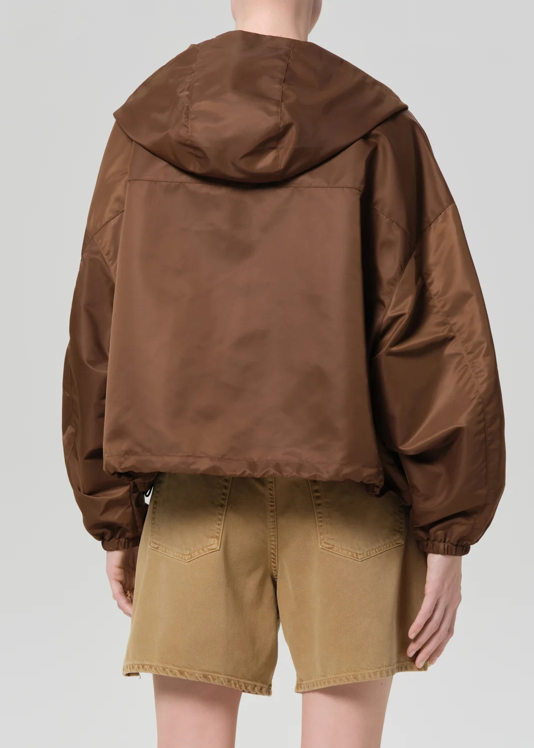 Citizens of Humanity Cropped Nylon Windbreaker in Brown, back view showing the hood