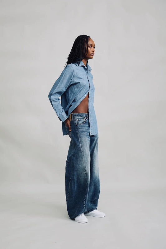 Denimist Remy Barrel Jean in Burke Indigo, side view on model, worn with a chambray shirt
