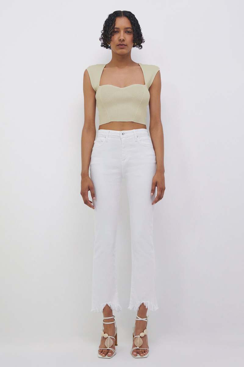 Front full-length view of the Simkhai Abia cropped rib-knit top in Almond with wide straps, worn with white jeans