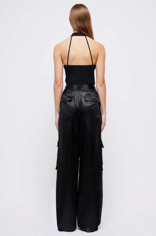 Back view of the Simkhai Beatriz wide-leg cargo pants in black satin, showing flap pockets
