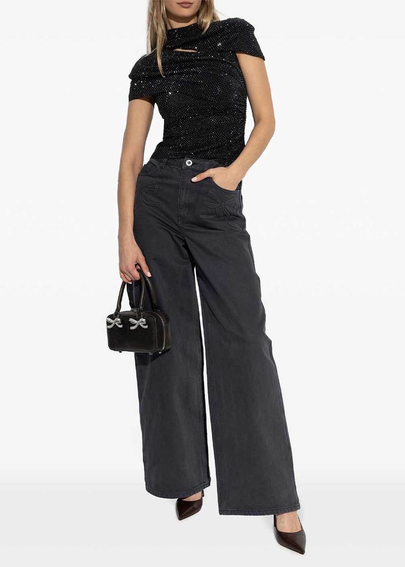 Full-length front view of the Self-Portrait rhinestone mesh cut-out top in black, styled with wide-leg jeans