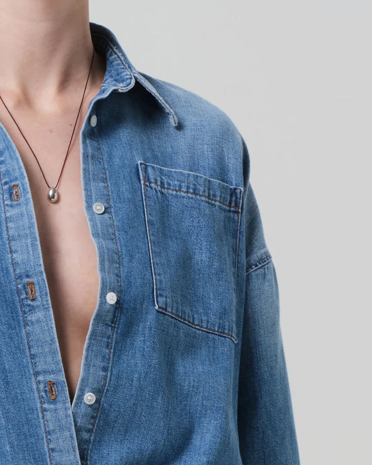 Citizens of Humanity Frances cropped cape button up shirt in Skyland light blue denim, close-up of collar, button front and chest pocket