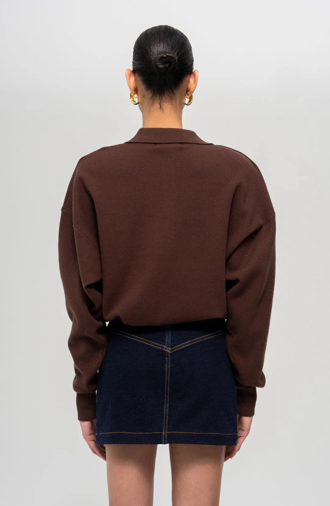 Back view of the Ronny Kobo Ninette Sweater in chocolate brown, showing cropped length, fitted ribbed knit, and subtle shoulder detailing — modern fall style from RTND.