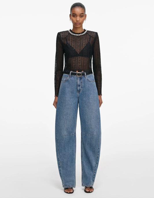Woman wearing Self Portrait Black Organza Lace Top with denim jeans