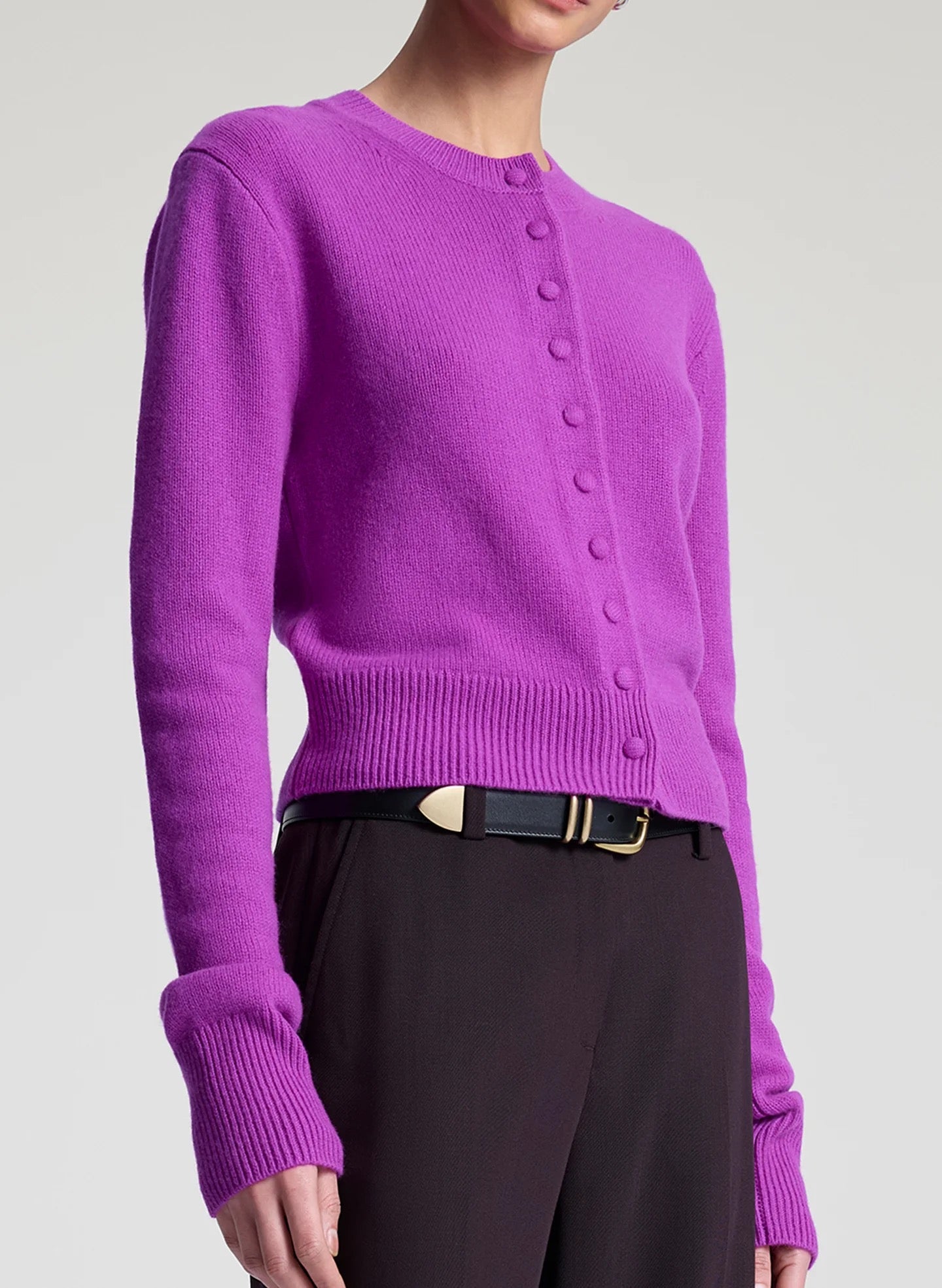 ALC Skyler Cashmere Cardigan in Fuchsia worn with stylish black pants, showcasing its cropped silhouette and button details.