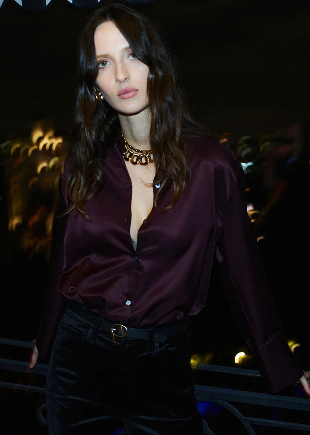 Model wearing Citizens Of Humanity Camilia shirt burgundy with chic accessories and dark trousers.