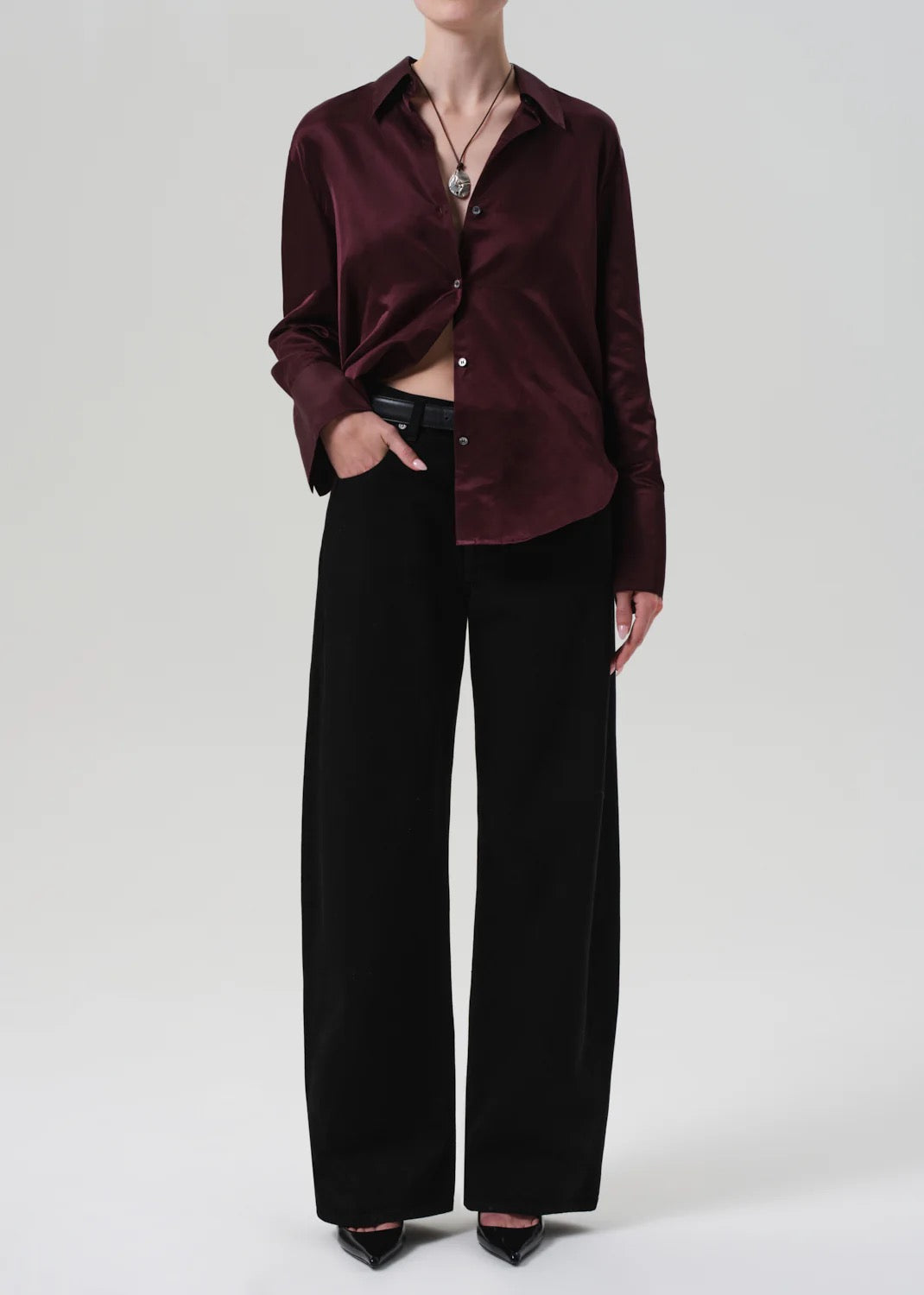 Camilia shirt burgundy styled outfit with black wide-leg trousers and accessories.
