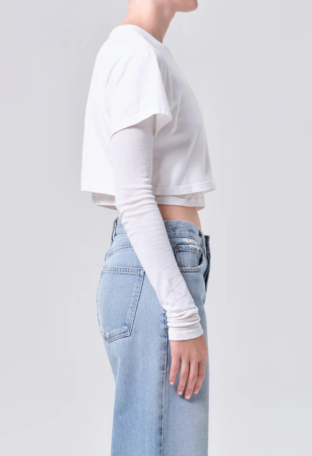 AGOLDE Romily Tee in White Ash, side view on model showing the cropped layered silhouette