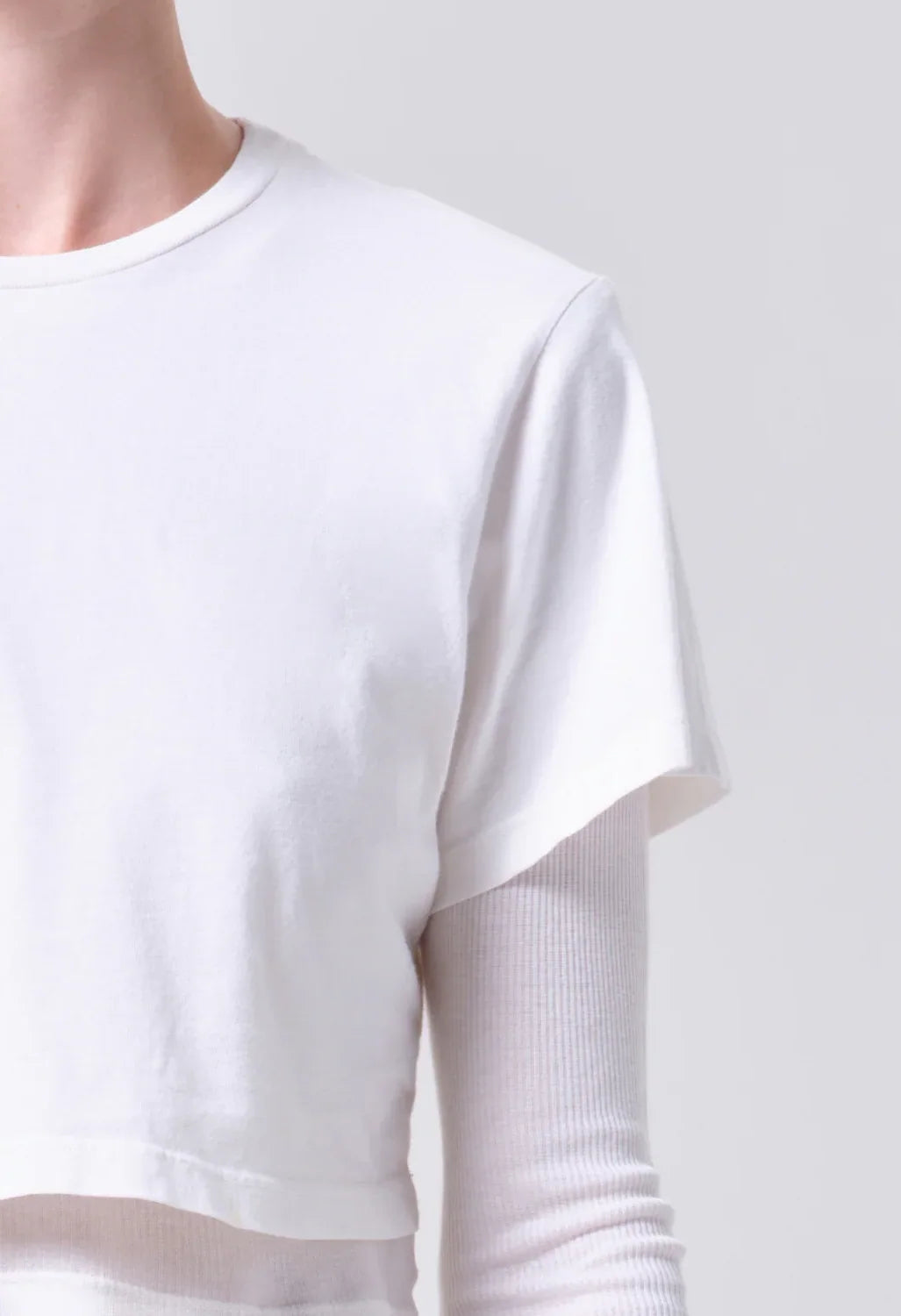 AGOLDE Romily Tee in White Ash, close-up of the crew neckline and short sleeve over the ribbed long-sleeve base layer