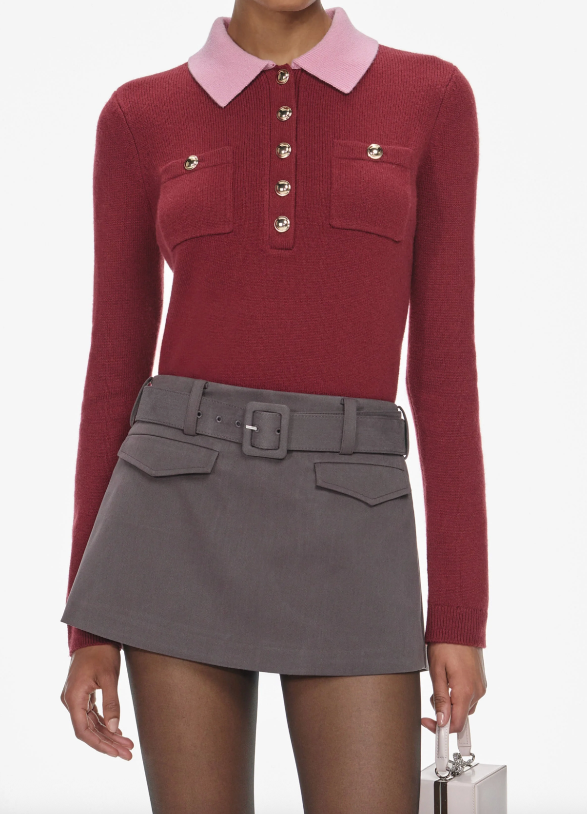 Red sweater with pink collar and gray skirt on a white background
