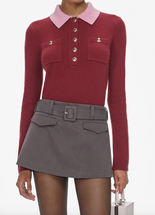 Red sweater with pink collar and gray skirt on a white background