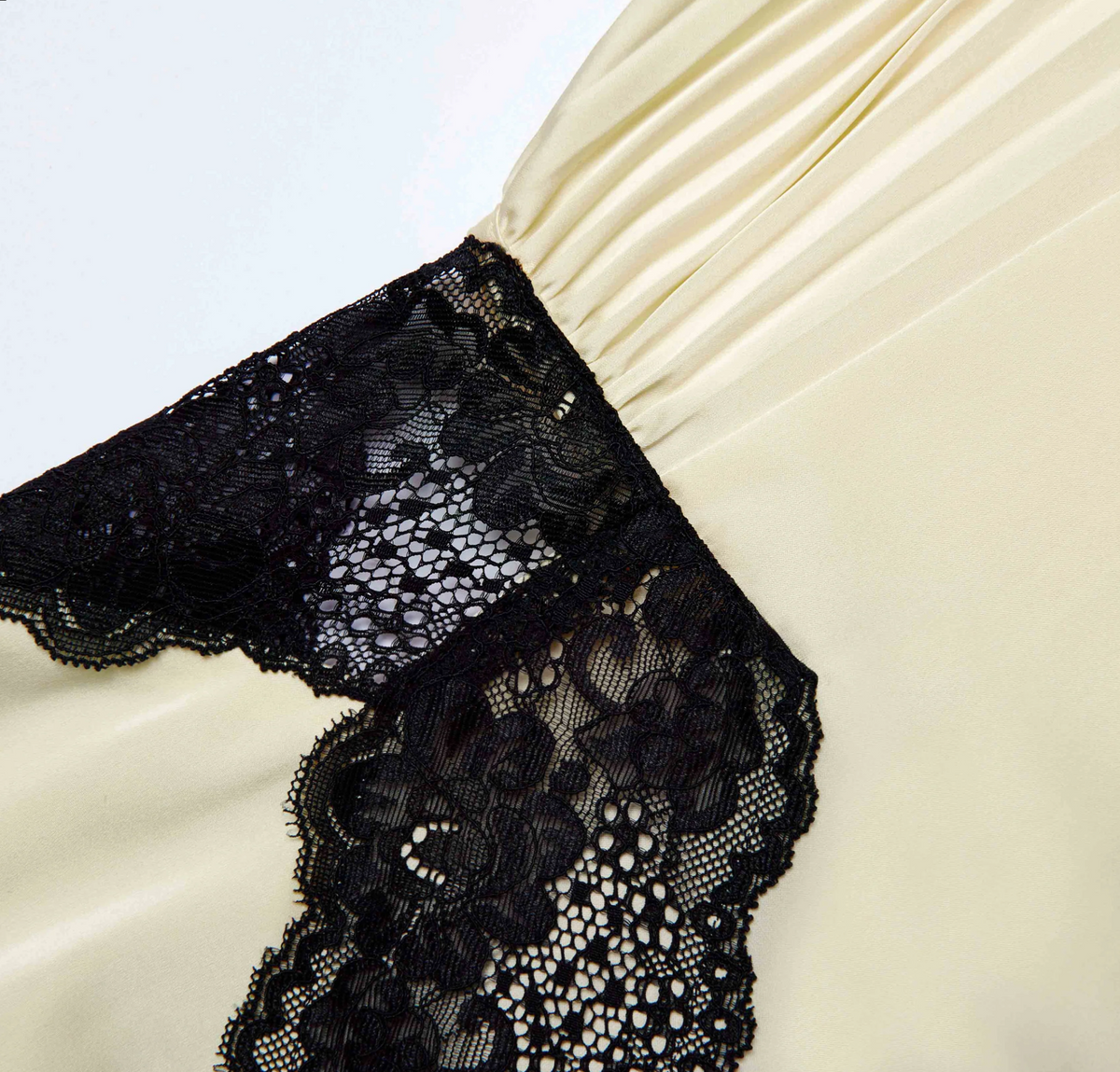 Close-up of the black lace and pleated satin of the Self-Portrait satin lace maxi dress in yellow