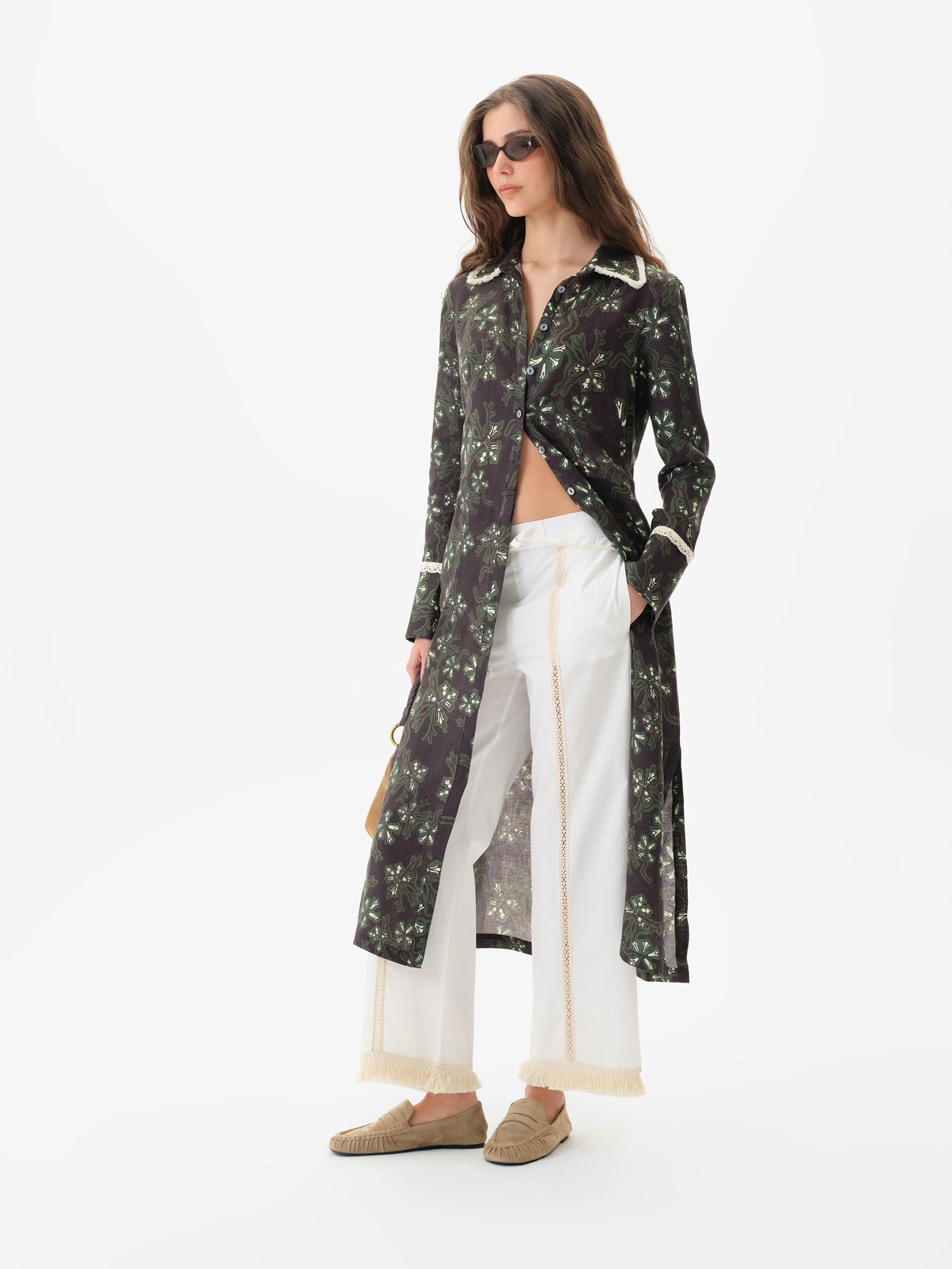 Side view of the white Savina pants styled under a long printed shirt dress