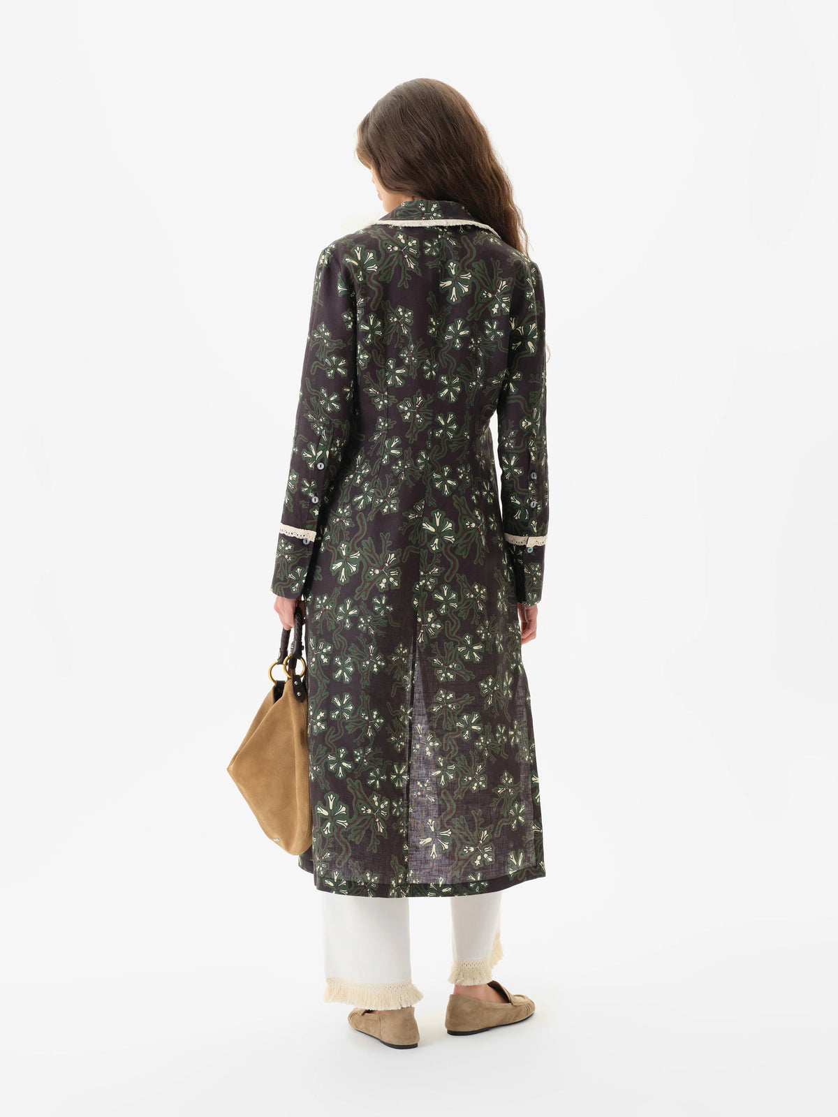 Back view of the white Savina pants styled under a long printed shirt dress
